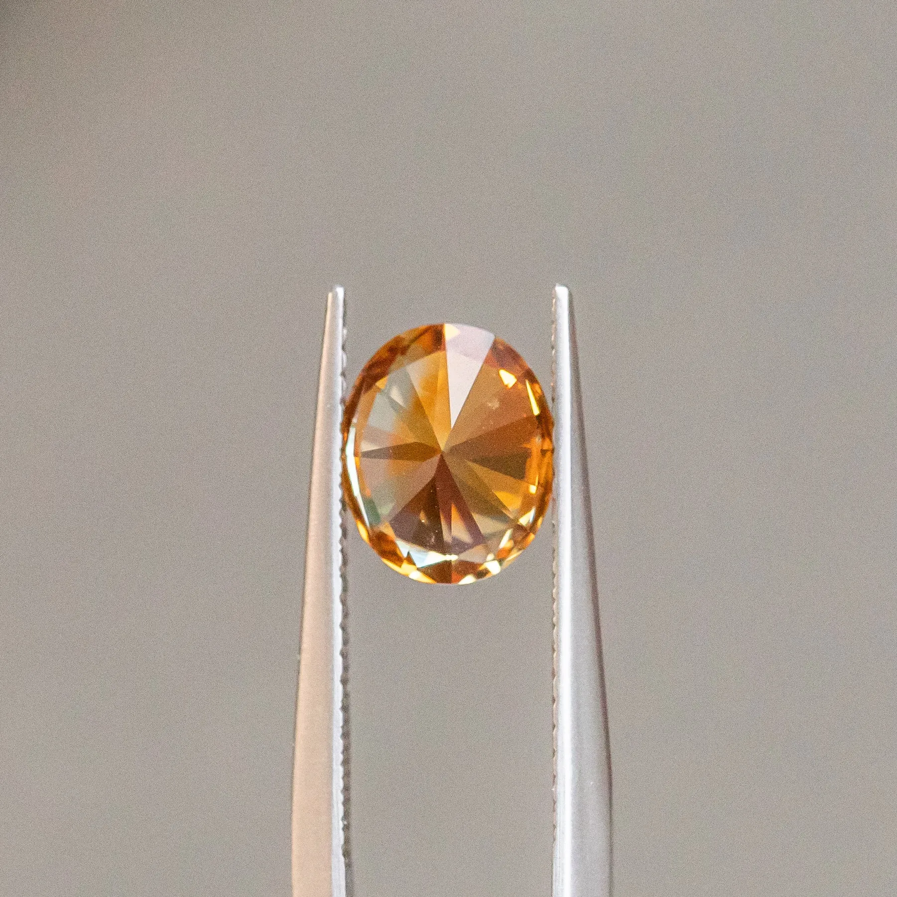 2.35CT OVAL PRECISION CUT MONTANA SAPPHIRE, BICOLOR PARTI ORANGE YELLOW CHAMPAGNE, 8.37X6.98MM